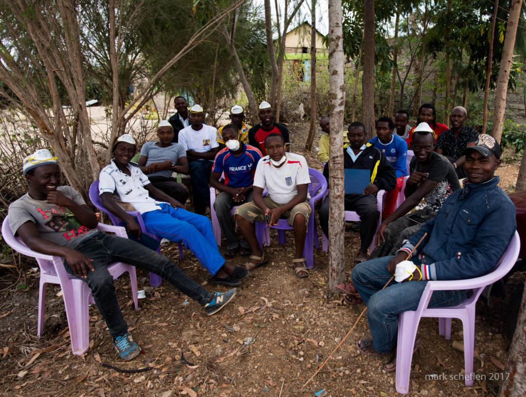 African Quarry men sitting in circle laughing